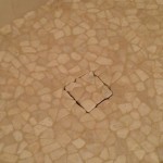 pebble shower floor with a tile drain insert