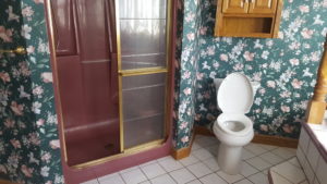 before picture of ugly bathroom and wallpaper in Juniata County